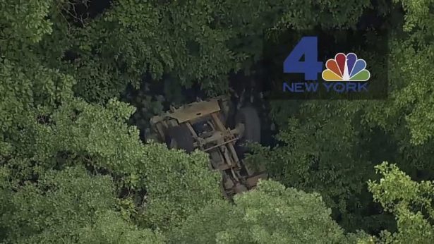 A light medium tactical vehicle sits overturned near the Camp Natural Bridge summer military training camp off Route 293,