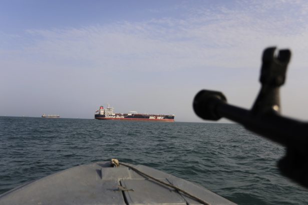 a speedboat of Iran's Revolutionary Guard trains a weapon toward the British-flagged oil tanker Stena Impero