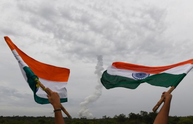 Indian residents wave Indian national flags