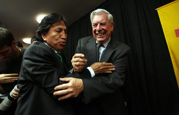 Peruvian writer Mario Vargas Llosa (R) is hugged by former Peruvian President Alejandro Toledo