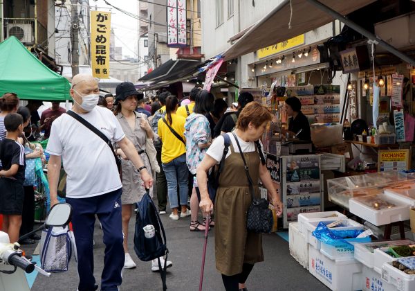 shoppers walking in front of Tsukiji's whale meat restaurant