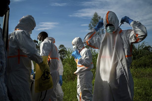 Burial workers put on protective