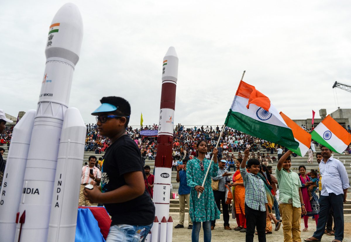 Students wave Indian national flags as the Indian Space Research Organisation's