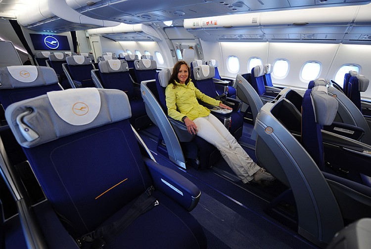 A young woman poses in a business class seat of the new airplane Airbus A380 A young woman poses in a business class seat of the new airplane Airbus A380