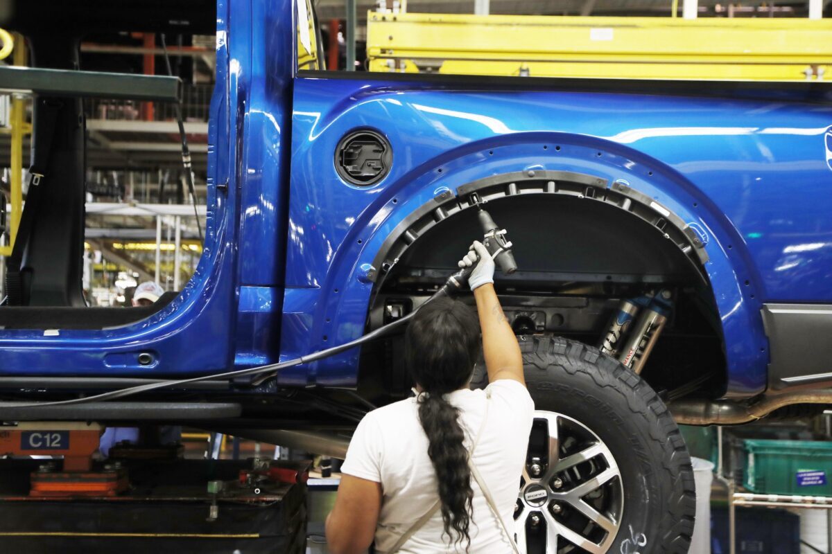 An assemblyman works on a 2018 Ford F-150 truck being assembled at the Ford Rouge assembly plant, in Dearborn, Michigan. on Sept. 27, 2018. (Carlos Osorio/AP-File)